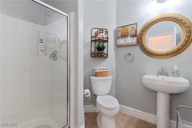 full bathroom with a stall shower, tile patterned flooring, baseboards, and toilet