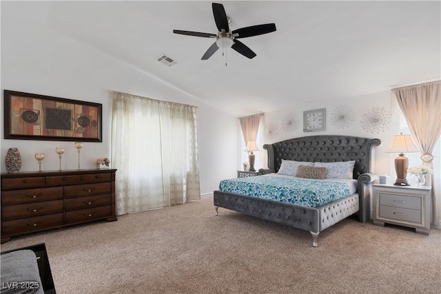 bedroom featuring lofted ceiling, ceiling fan, light carpet, and visible vents