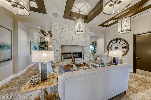 living room with beam ceiling, a fireplace, baseboards, and wood finished floors