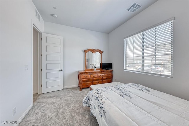 bedroom featuring light colored carpet, visible vents, and baseboards