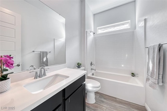 full bathroom with wood finished floors, vanity, toilet, and shower / bathtub combination