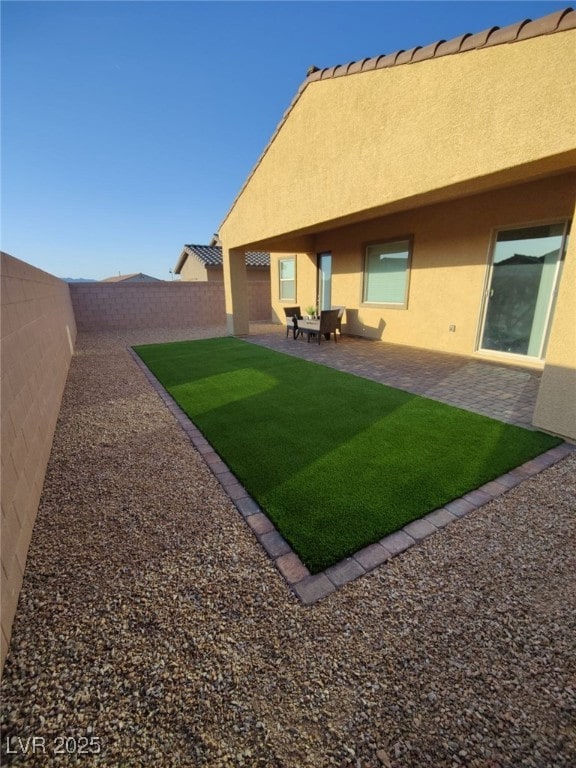 view of yard featuring a patio and a fenced backyard