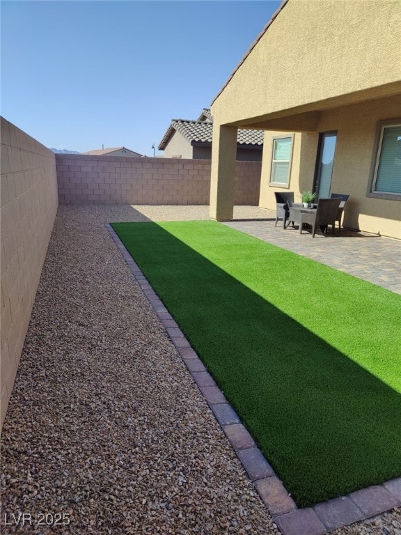 view of yard with a fenced backyard and a patio