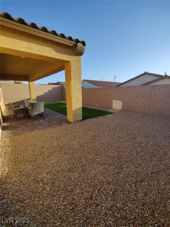 view of yard with a patio area and a fenced backyard