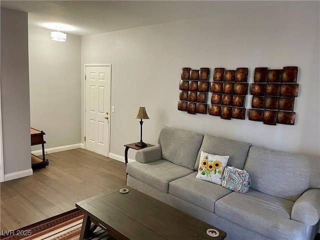 living room featuring baseboards and wood finished floors