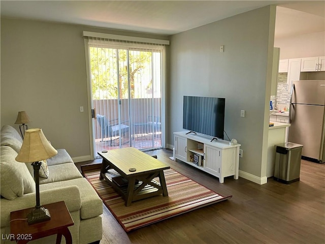 living room featuring baseboards and dark wood-style flooring