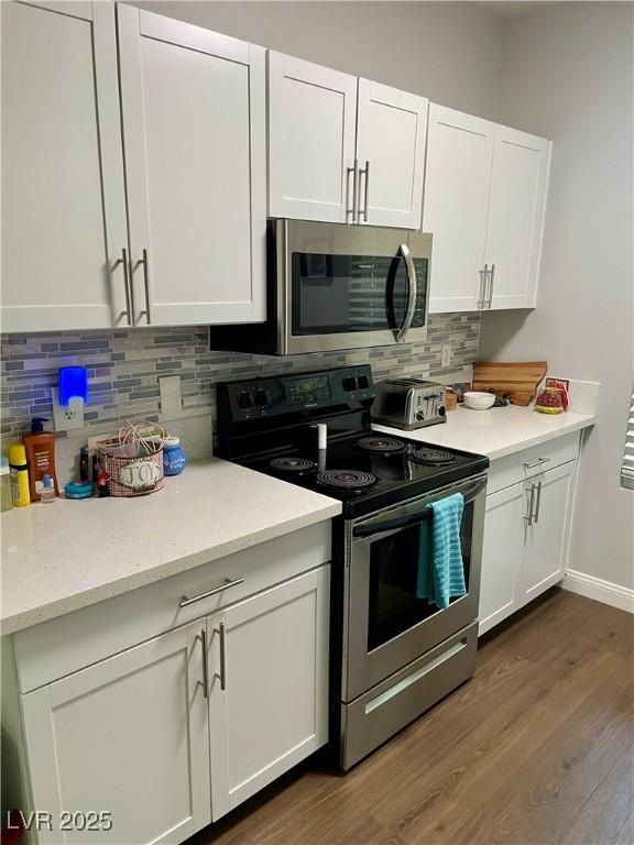 kitchen with appliances with stainless steel finishes and white cabinetry