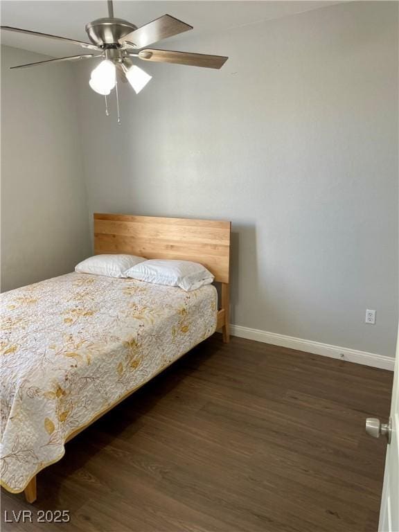 bedroom featuring dark wood finished floors, a ceiling fan, and baseboards