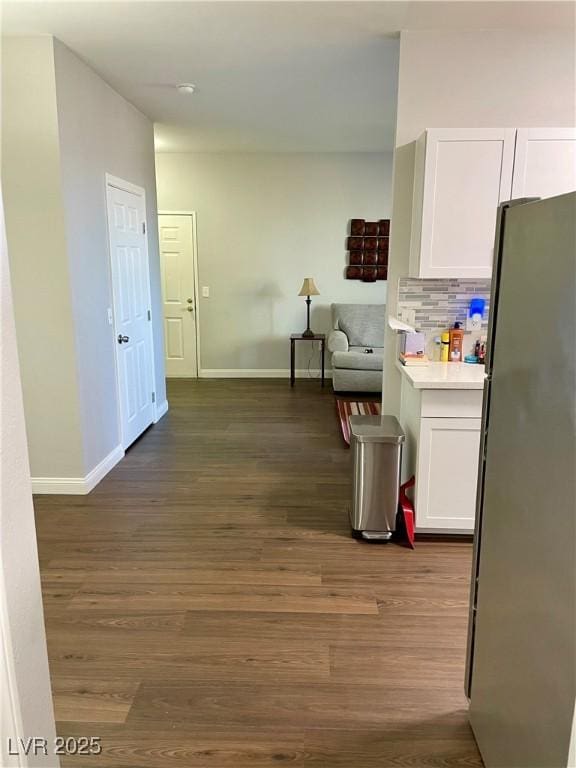 interior space with dark wood-style flooring and baseboards