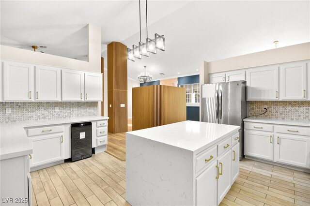 kitchen with light countertops, pendant lighting, white cabinetry, and a kitchen island