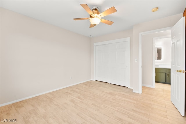 unfurnished bedroom with light wood-style floors, a closet, ceiling fan, and baseboards