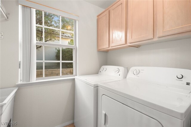 washroom featuring washing machine and dryer and cabinet space