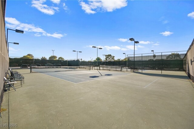 view of sport court featuring fence