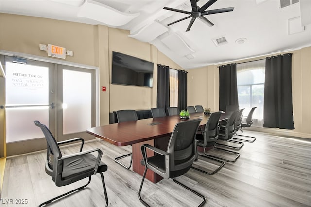 office space featuring french doors, lofted ceiling, visible vents, light wood-style floors, and ceiling fan