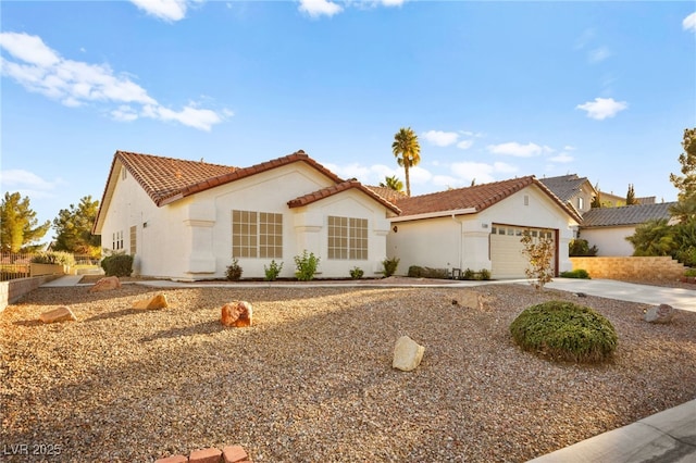 mediterranean / spanish-style home with a garage, a tile roof, driveway, and stucco siding