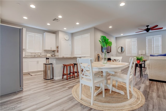 dining room with visible vents, light wood-style flooring, and recessed lighting