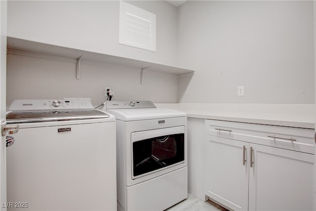 clothes washing area with cabinet space and independent washer and dryer