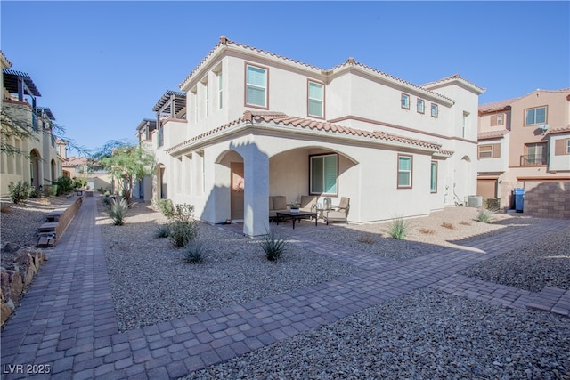 back of house with a residential view, a patio area, a tile roof, and stucco siding