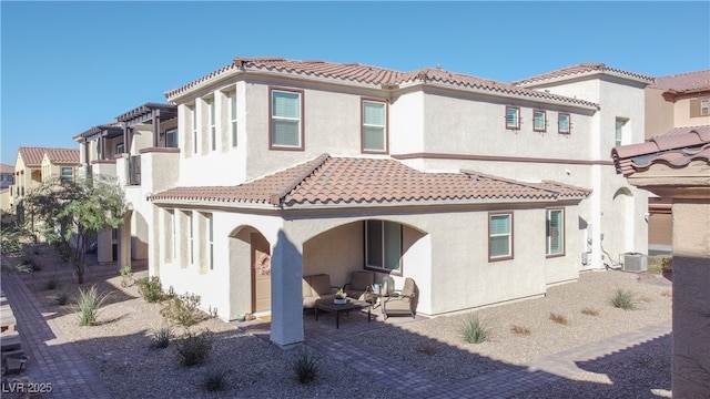 back of house with cooling unit, a patio, stucco siding, a residential view, and a tiled roof