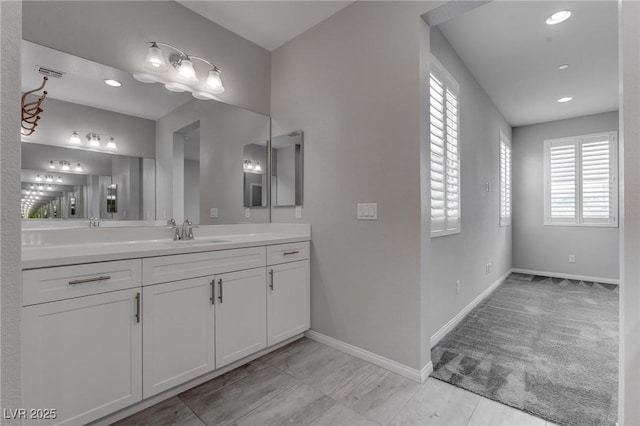 bathroom with visible vents, baseboards, vanity, and recessed lighting