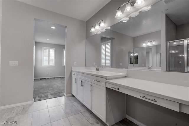 full bath with tile patterned floors, vanity, baseboards, and a shower stall