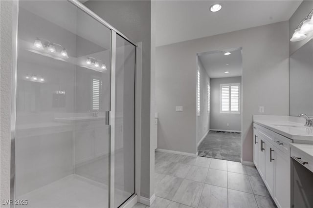 full bath with recessed lighting, baseboards, a shower stall, tile patterned floors, and vanity