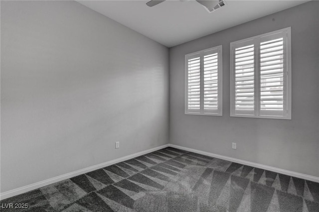 unfurnished room featuring baseboards, dark colored carpet, visible vents, and a ceiling fan