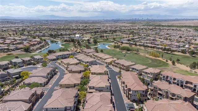 drone / aerial view featuring a water and mountain view and a residential view