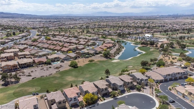 birds eye view of property featuring a water and mountain view, view of golf course, and a residential view