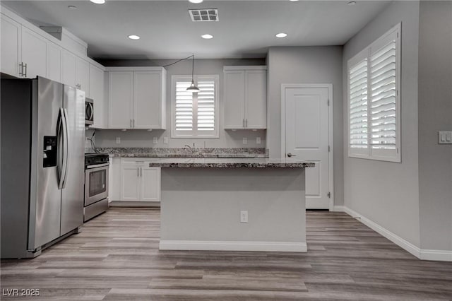 kitchen with visible vents, white cabinets, appliances with stainless steel finishes, and light stone countertops