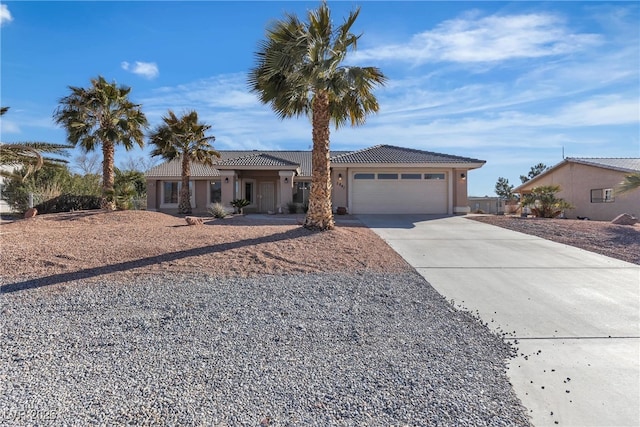 ranch-style house with an attached garage, a tile roof, concrete driveway, and stucco siding