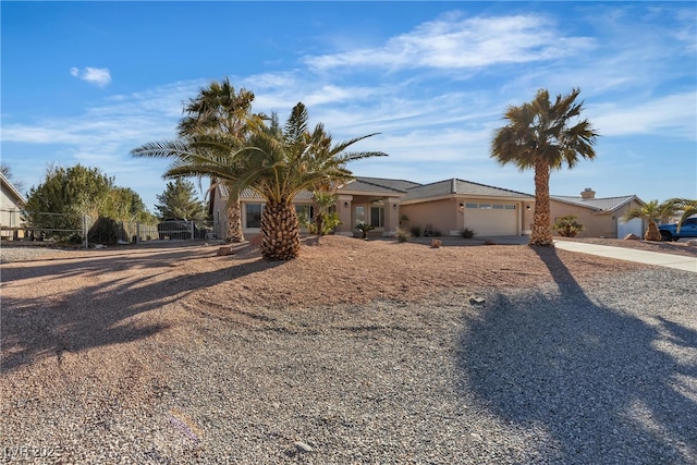 view of front facade with concrete driveway and an attached garage