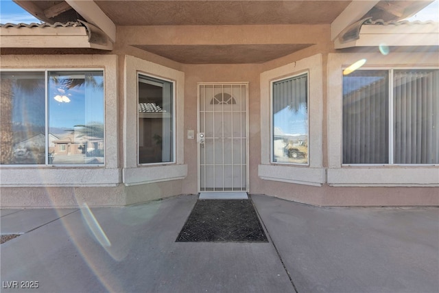 entrance to property with stucco siding