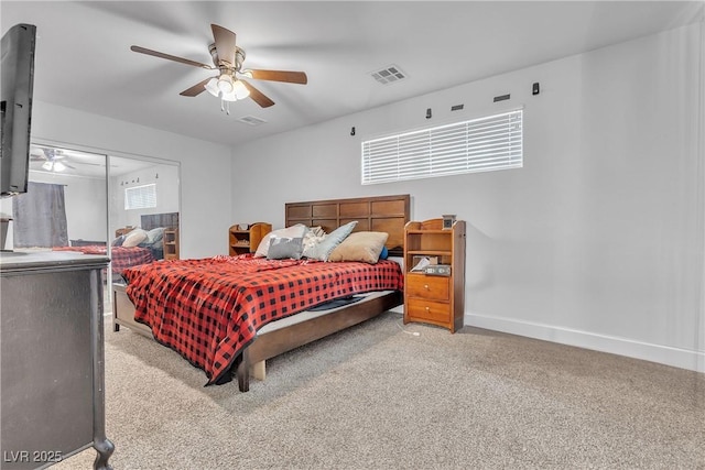 carpeted bedroom featuring a ceiling fan, a closet, visible vents, and baseboards