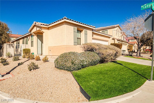 view of side of property with a garage, a tile roof, a lawn, and stucco siding