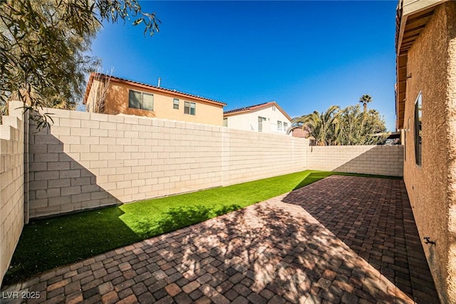 view of yard featuring a patio area and a fenced backyard