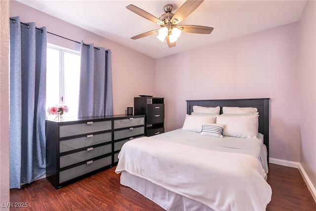 bedroom featuring ceiling fan, dark wood finished floors, and baseboards