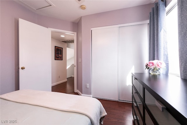 bedroom featuring a closet, visible vents, and dark wood finished floors