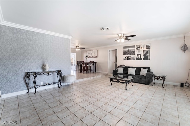 living area featuring wallpapered walls, an accent wall, baseboards, and crown molding