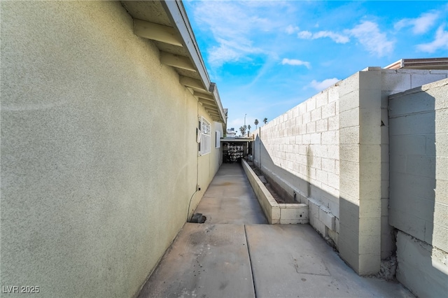 view of property exterior with fence and stucco siding