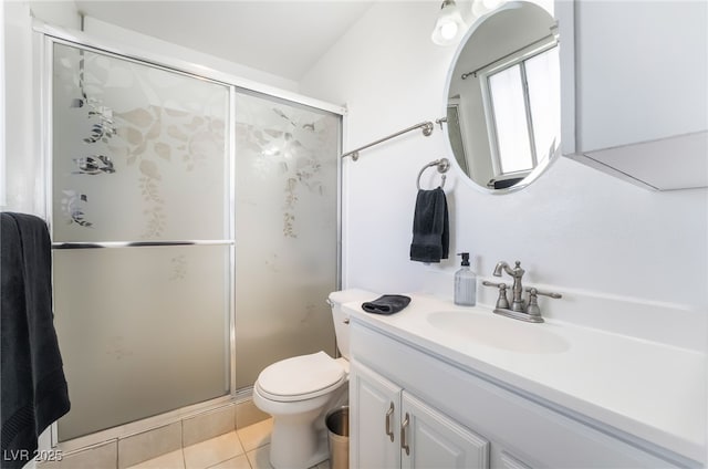 bathroom featuring toilet, a stall shower, vanity, and tile patterned floors