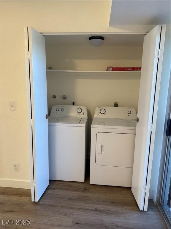 clothes washing area with dark wood-style floors, baseboards, laundry area, and separate washer and dryer