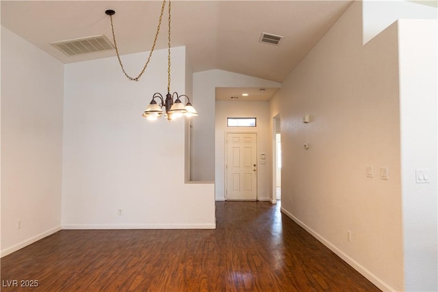 interior space with lofted ceiling, dark wood-type flooring, visible vents, and a notable chandelier