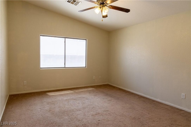 spare room featuring light carpet, baseboards, visible vents, a ceiling fan, and lofted ceiling