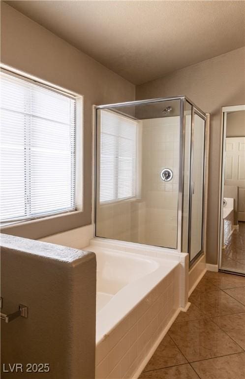 full bath featuring a shower stall and tile patterned floors