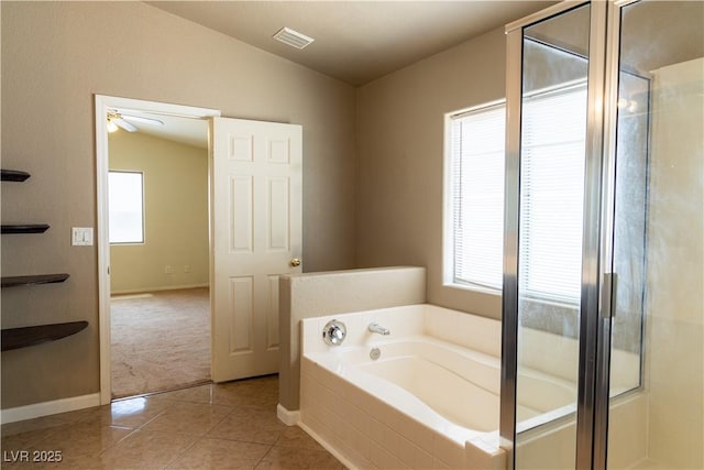 full bathroom with lofted ceiling, visible vents, a stall shower, a bath, and tile patterned floors