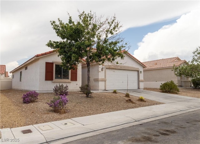 view of front of property featuring driveway, a tile roof, a garage, and stucco siding