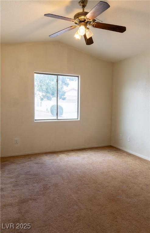 unfurnished room with lofted ceiling, ceiling fan, baseboards, and carpet flooring