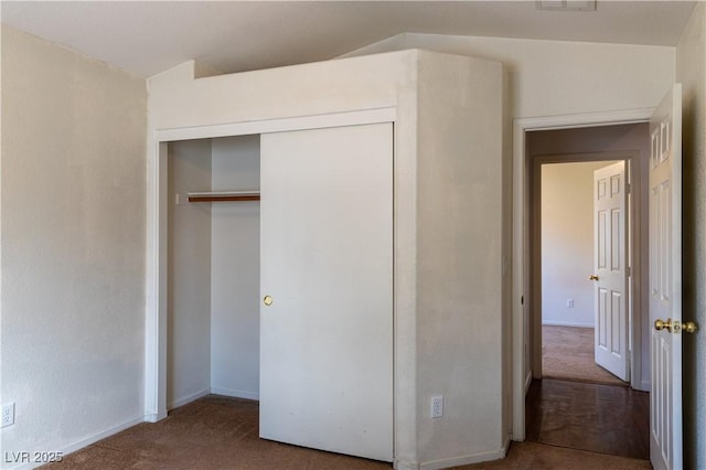 unfurnished bedroom featuring carpet floors and a closet