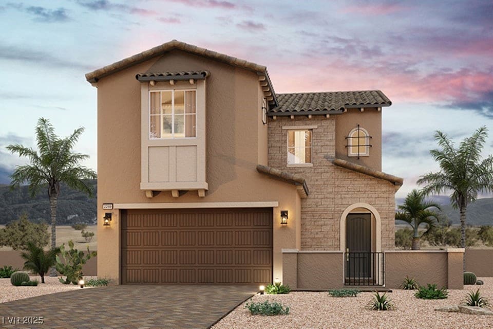 mediterranean / spanish-style house featuring a garage, a tile roof, stone siding, decorative driveway, and stucco siding